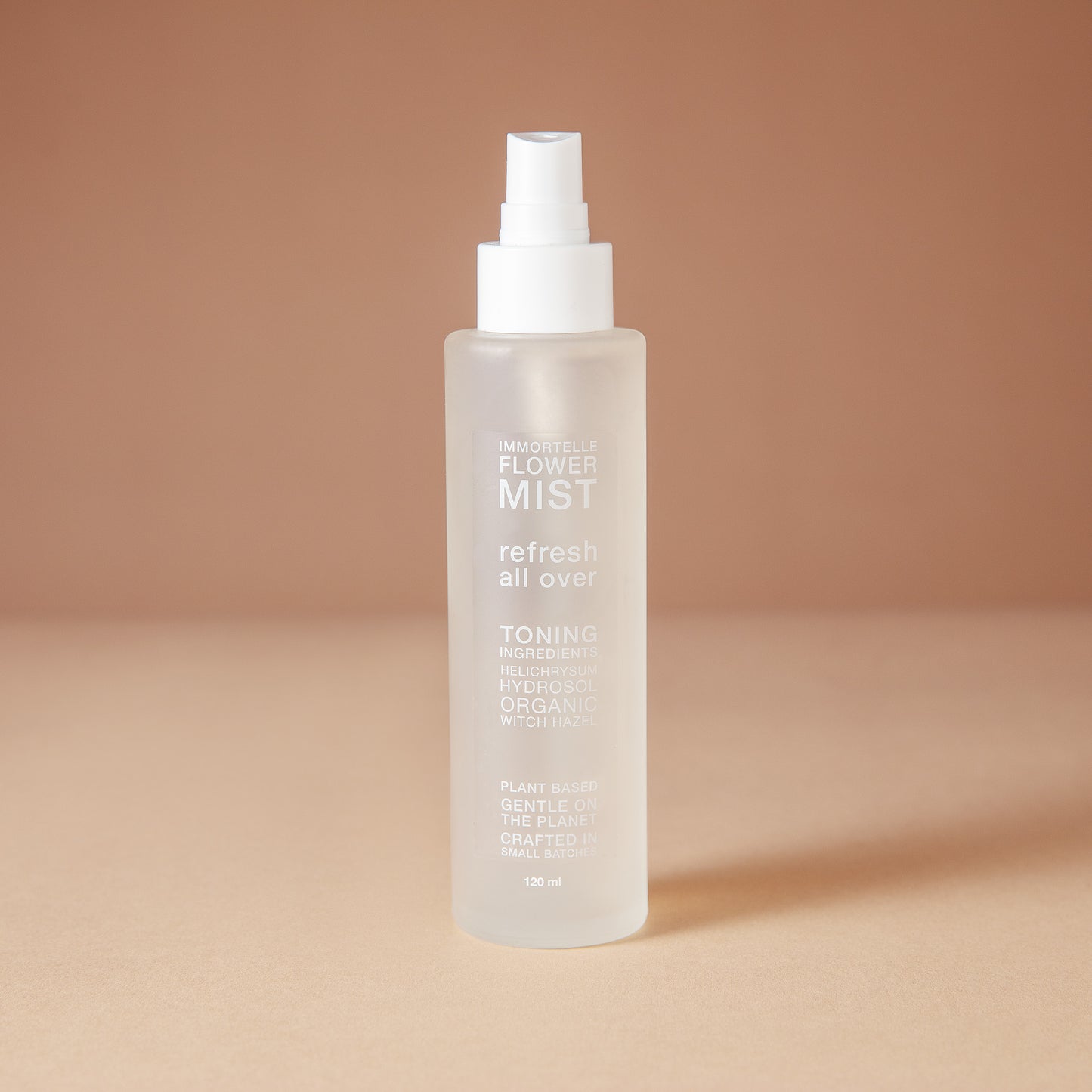DEAR BOTANICS facial mist in a 120 ml frosted glass spray bottle with a white pump dispenser, set against a warm beige background.