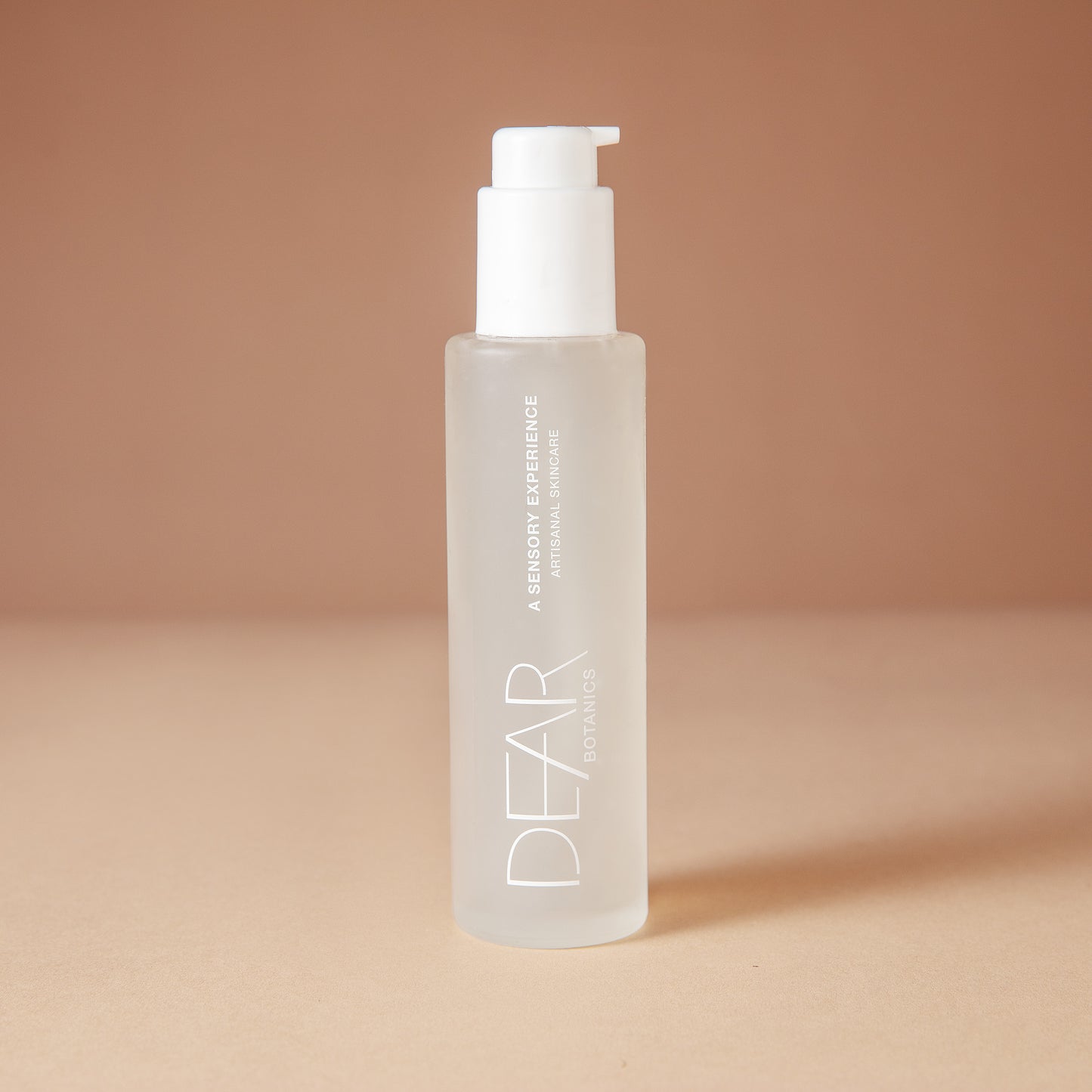 DEAR BOTANICS Face Wash in a 4 ounce frosted glass bottle with a white pump dispenser, set against a warm beige background.